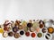 Various dry spices flat lay in small bowls on white wood background. Top view, copy space