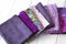 Various fabric material sample swatches,  with a purple theme