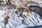 Various fishes on a outdoor market stall with vegetables, close up