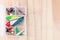 Various fishing lures in plastic box on wooden background, horizontal, top view, copy space