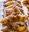 Various flavours of croissant or as in Italy their called brioche on display in a bakery in Milan, Italy with a price and sign - A