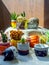 Various flowers and cactus plants with many geometric concrete planters. Painted concrete pots for home decoration