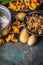 Various forest Mushrooms with potato on rustic kitchen table background, top view, place for text. Seasonal Autumn cooking