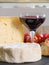 Various french cheeses with glass of red wine