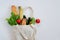 Various fresh vegetables and fruits, bread, cereals in an eco reusable bag.