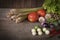 Various fresh, young homegrown vegetables, tomato, lemon grass, chilli, lettuce, Eggplant, garlic place on a wooden table