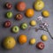 Various fruits with almond flowers, gray background