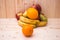 Various fruits apples, bananas, oranges, pomegranates on natural wooden background