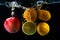Various fruits clementine, lemon and apple splash of water on bl