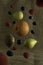 Various fruits such as orange, kiwi, pear, raspberry and blueberry levitating on a sackcloth background