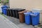 Various garbage cans stand on the street