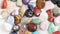 Various gemstones rotating on white table close up