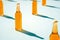 Various glass bottles with shadows on blue background