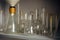 Various glass flasks on the shelf, close-up. Equipment for experiments in the school laboratory. Used empty test tubes