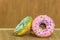 various glazed donuts isolate on wooden background