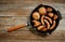 Various grilled meat and fried potatoes on cast iron pan