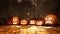 Various halloween pumpkins in fall forest at dusk