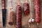 Various hanging salami sausages