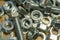 Various hardware. Metal fasteners. Bolts, nuts and washers. Soft focus, abstract, industrial background