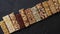 Various healthy granola bars placed in a row on black stone table