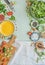 Various healthy salad ingredients on light green kitchen table background. Top view. Healthy lunch preparation, Frame