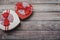 Various heart shaped boxes on an old wood background with copy space. Gift card