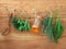 Various herbs hanging on shabby wooden background. Parsley ,sage,rosemary, fennel, shallot, thyme and essential bottles for