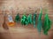 Various herbs hanging on shabby wooden background. Parsley ,sage,rosemary, fennel, shallot, thyme and essential bottles for