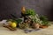 Various herbs and spices, lemons and olive oil on a wooden table