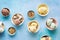 Various ice cream desserts in bowls on rustic blue background