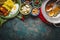 Various indian food bowls with curry, yogurt , rice, bread , chicken, chutney, paneer cheese and spices on dark rustic background,