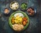 Various indian food bowls with curry, yogurt ,rice,bread ,chutney, paneer cheese and spices on dark rustic background