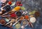 Various indian spices, nuts and herbs in wooden spoons and metal bowls