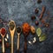 Various indian spices in wooden spoons, herbs and nuts