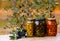 Various jars with olive oil and plates with olives under the olive tree