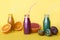 Various kind of smoothies or juices in bottles, healthy diet food concept on yellow.