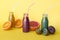 Various kind of smoothies or juices in bottles, healthy diet food concept on yellow background.