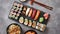 Various kinds of sushi placed on black stone board