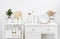 Various kitchen utensils and dishware with elegant vintage white furniture