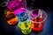 Various laboratory beakers and cylinders filled with colorful liquids o