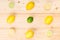 Various lemons and lime, spread out on wooden boards