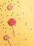 Various lollipops with shining sparkles on a yellow background.