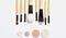 Various makeup brushes and pink nude eyeshadows on a white background