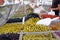 Various marinated olives for sale in a market window