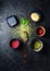 Various matcha tea powder on a concrete background. Wooden spoon with scattered matcha tea powder with leaves