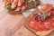 Various meat snacks, charcuterie board with several types of sausages - salami, bresaola, proscuitto