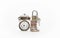 Various money coins stack with padlock and keys on top beside the old vintage classic clocks isolated on white