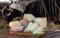 Various natural cheeses on wooden table in outdoor cowshed