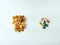 Various nut mix and different medical drug pills, tablets and capsules placed on white background as balance between natural and