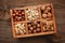 Various nuts selection: peanuts, hazelnuts, chestnuts, walnuts, pistachio and pecans in wooden box. Top view with space for your